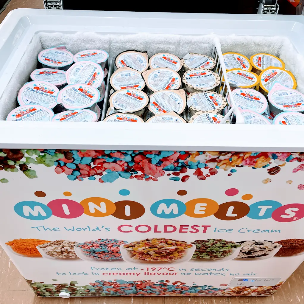 Ice cream freezer at Eagle Mini Mart with cups of frozen dessert
